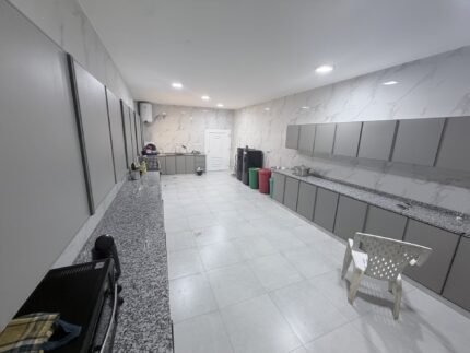 Fully renovated villa kitchen with grey cabinetry and granite countertops