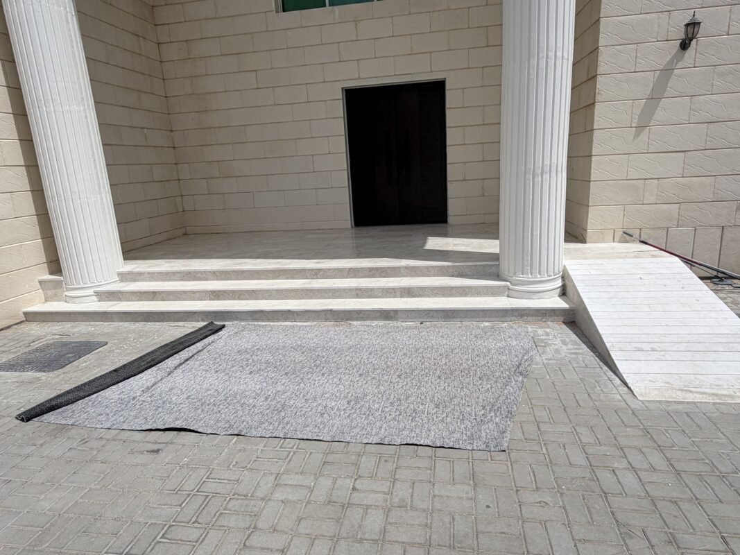 Villa entrance with classic columns and steps after renovation, Al Ain