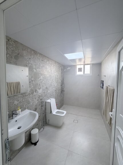 New porcelain-tiled bathroom with skylight and walk-in shower, Al Ain