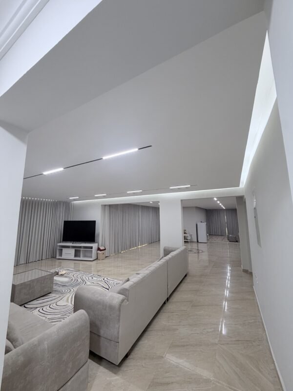 Living room with modern gypsum ceiling and cove lighting after renovation