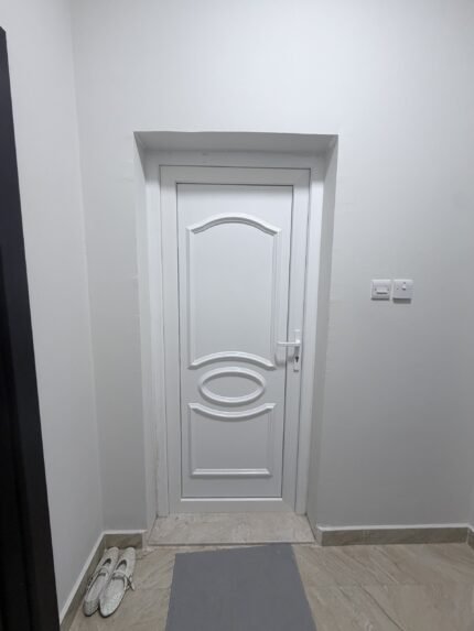 Elegant dark WPC interior door installed during villa renovation in Al Ain