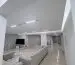Living room with modern gypsum ceiling and cove lighting after renovation